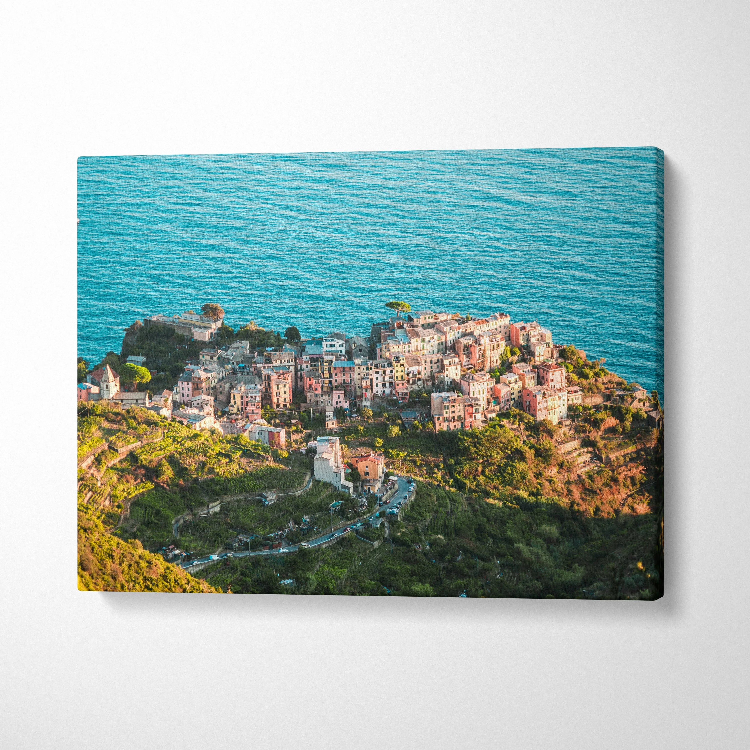 Canvas wall art featuring colorful coastal buildings overlooking a vibrant blue ocean.