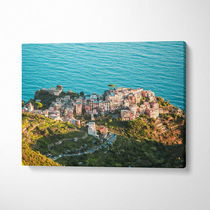 Canvas wall art featuring colorful coastal buildings overlooking a vibrant blue ocean.