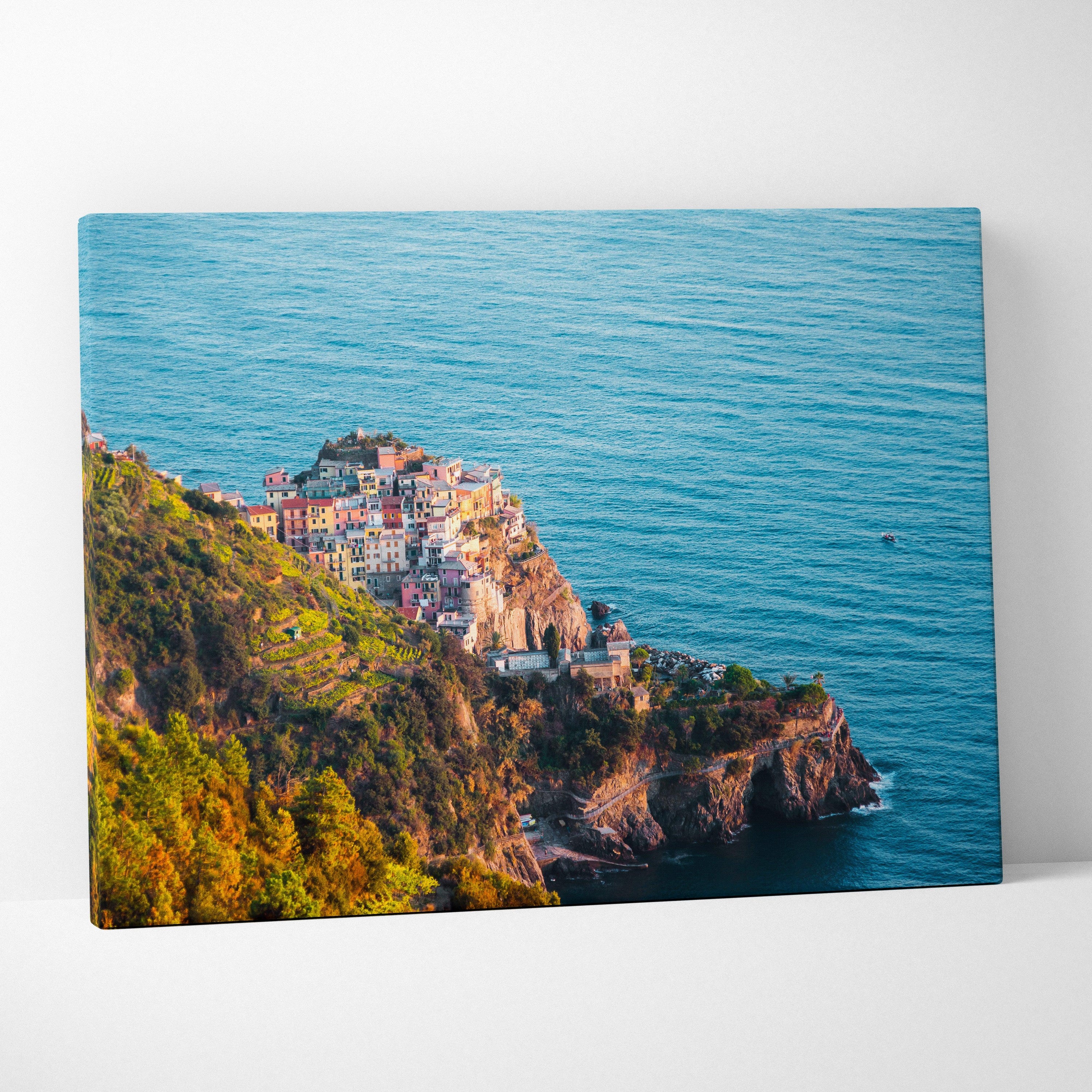 Canvas wall art featuring vibrant digital ocean scene with coastal buildings on rocky cliffs.