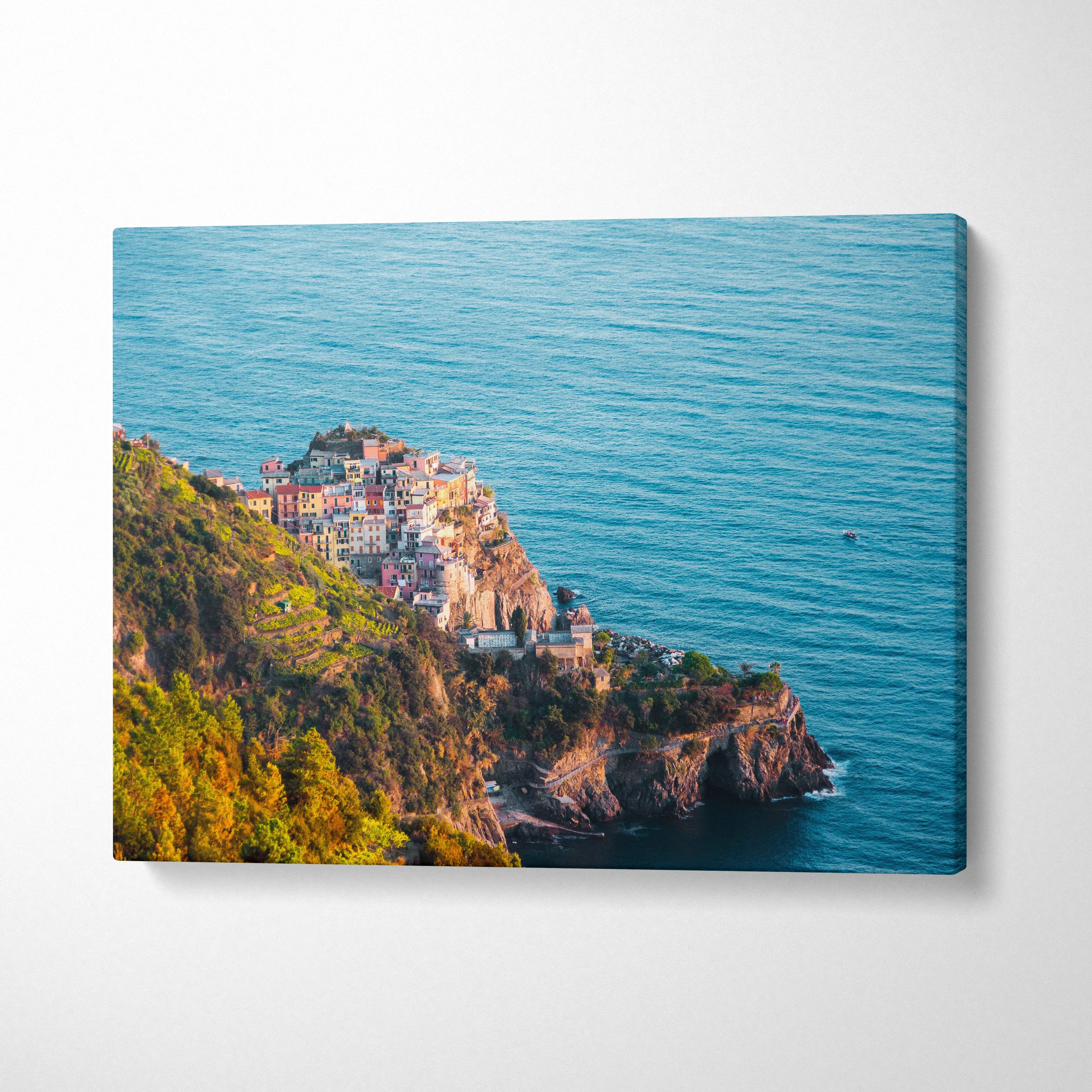 Ocean cliffside village with colorful buildings on canvas wall art in horizontal orientation.