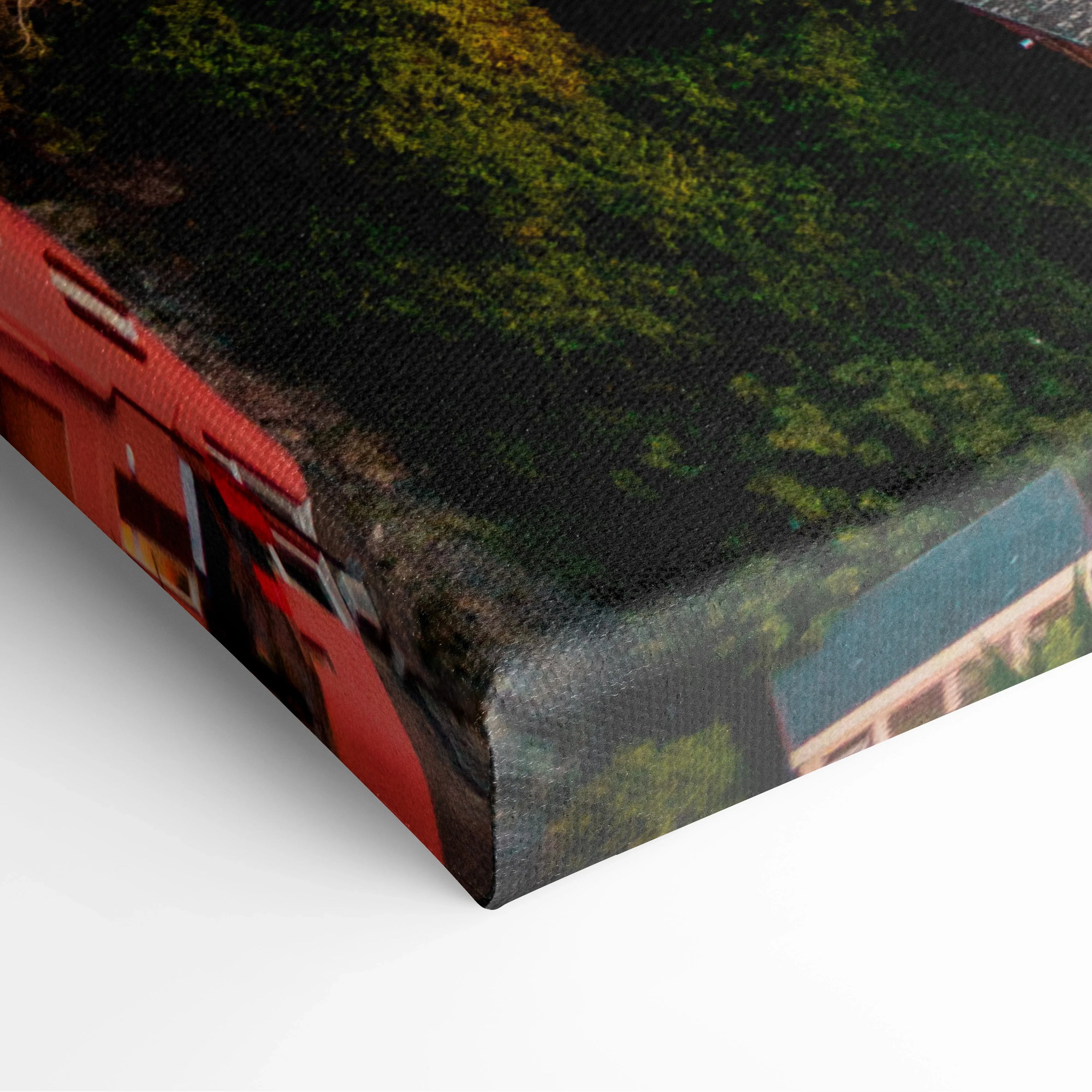 Close-up of canvas wall art corner showing textured fabric print with urban architecture and ocean theme in vivid colors.