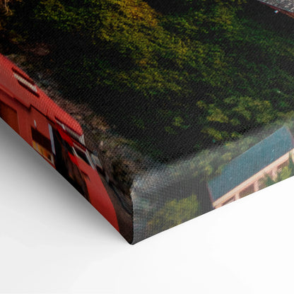 Close-up of canvas wall art corner showing textured fabric print with urban architecture and ocean theme in vivid colors.