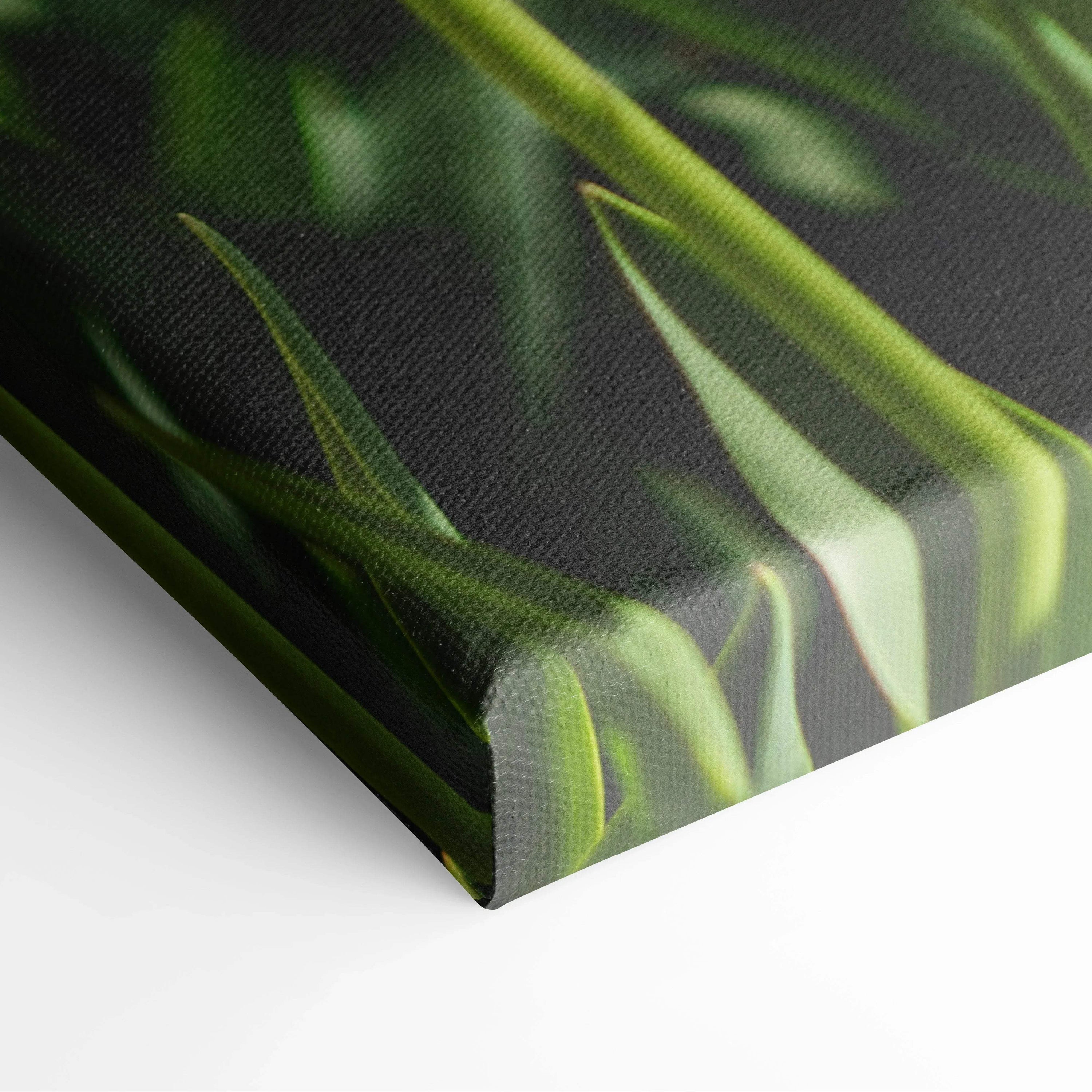 Close-up of vibrant yellow tulips on textured canvas wall art with lush green leaves decor.