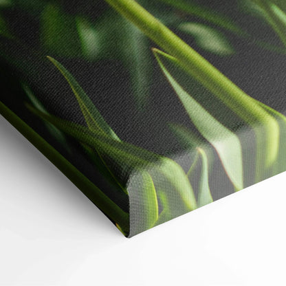Close-up of vibrant yellow tulips on textured canvas wall art with lush green leaves decor.