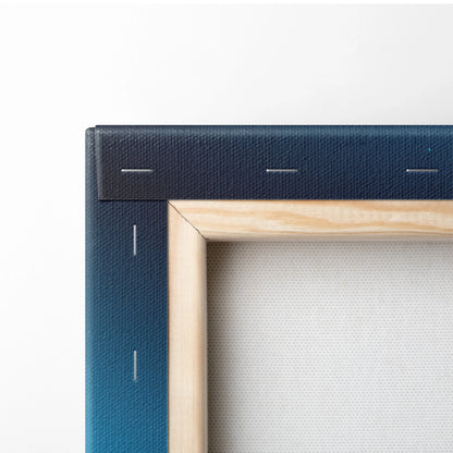 Close-up of canvas wall art corner with navy blue ocean-themed print and natural wood frame edges.