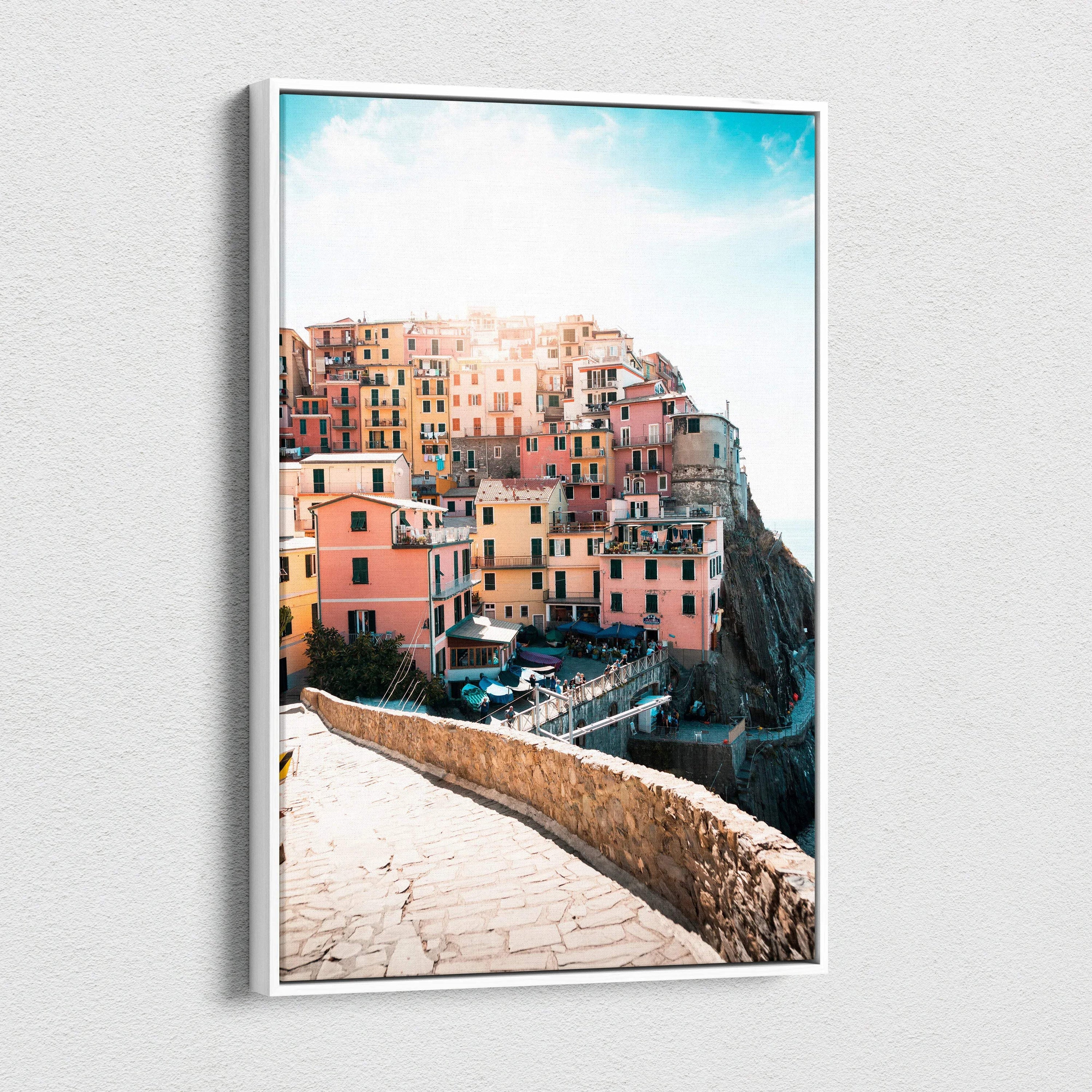 Canvas wall art featuring colorful Mediterranean cliffside buildings under a bright blue sky.