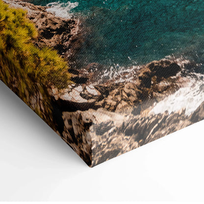 Close-up of canvas wall art showing textured rocky coastline and blue water with green trees in digital style.