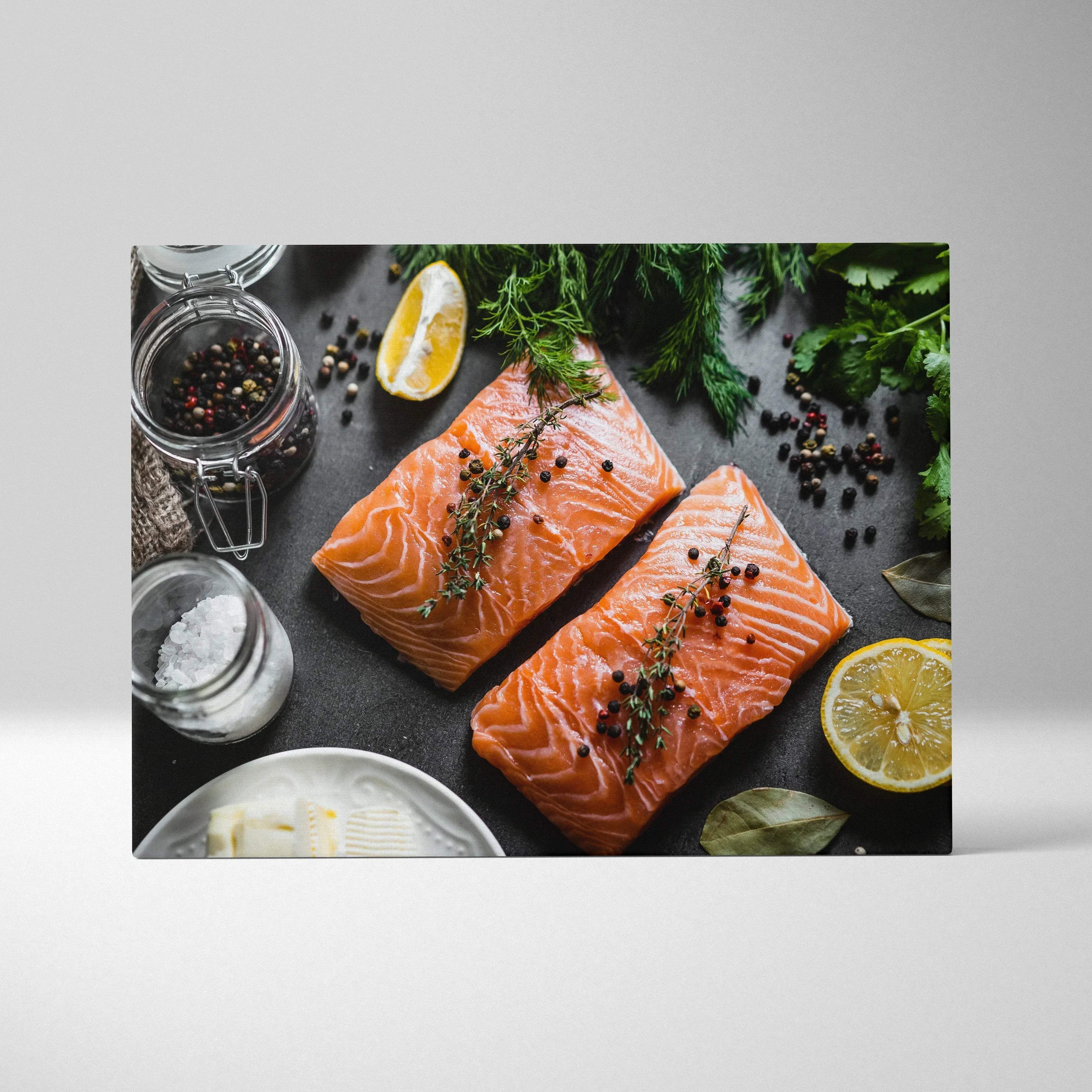 Canvas wall art featuring two raw salmon fillets garnished with herbs and peppercorns on a dark surface, accented with lemon