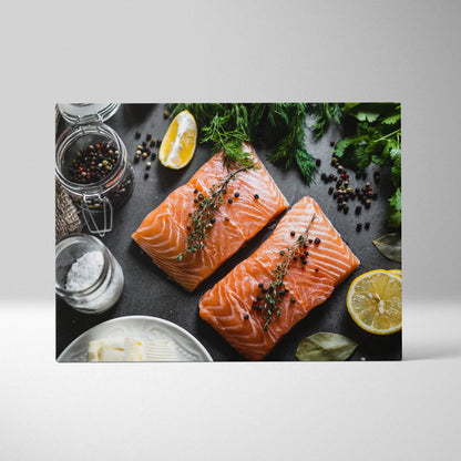 Canvas wall art featuring two raw salmon fillets garnished with herbs and peppercorns on a dark surface, accented with lemon