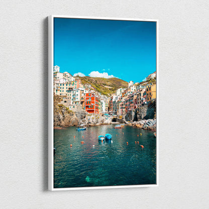 Vertical canvas wall art featuring colorful coastal buildings and tranquil blue water under a bright sky.