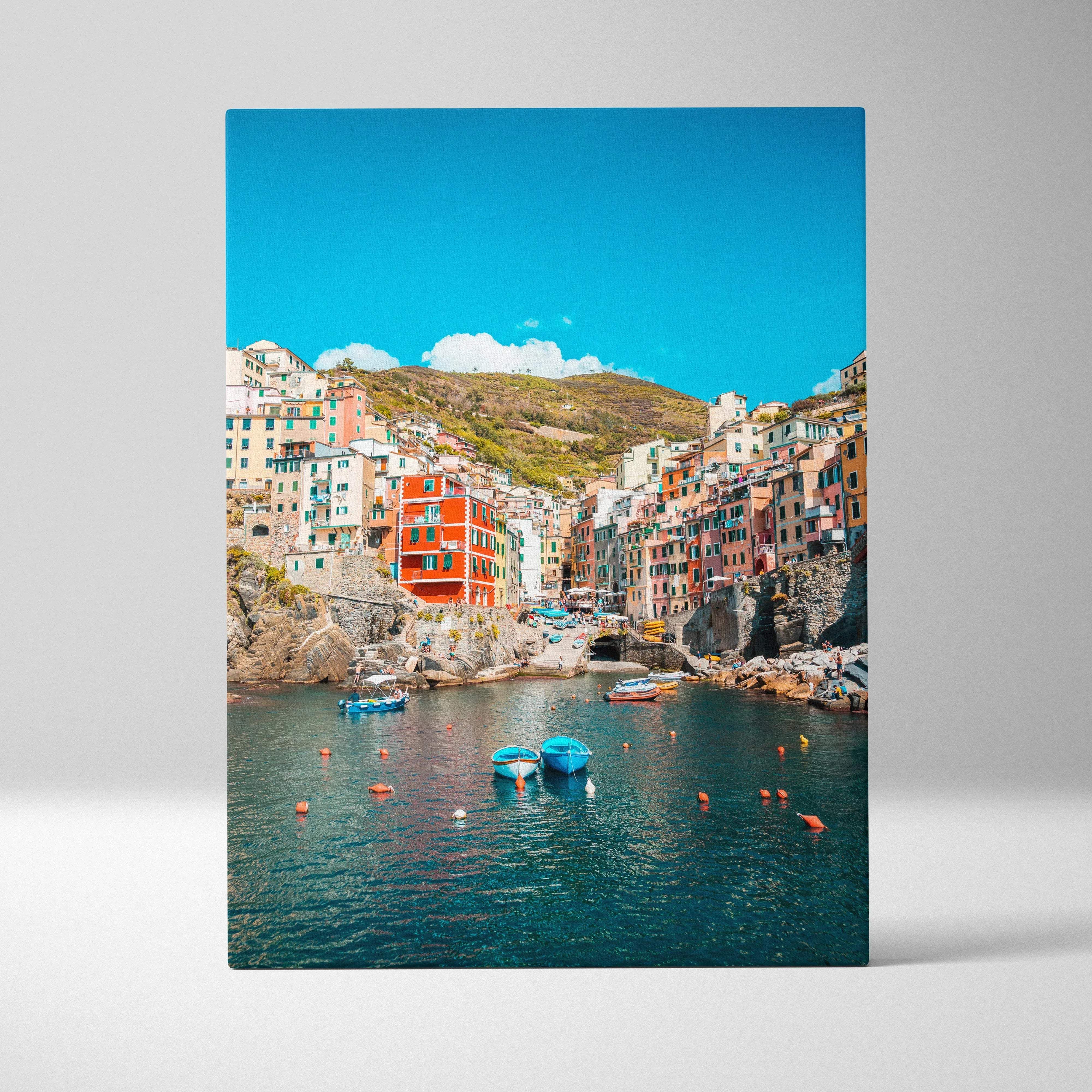 Vibrant coastal village scene with colorful buildings and turquoise waters on a rectangular canvas wall art