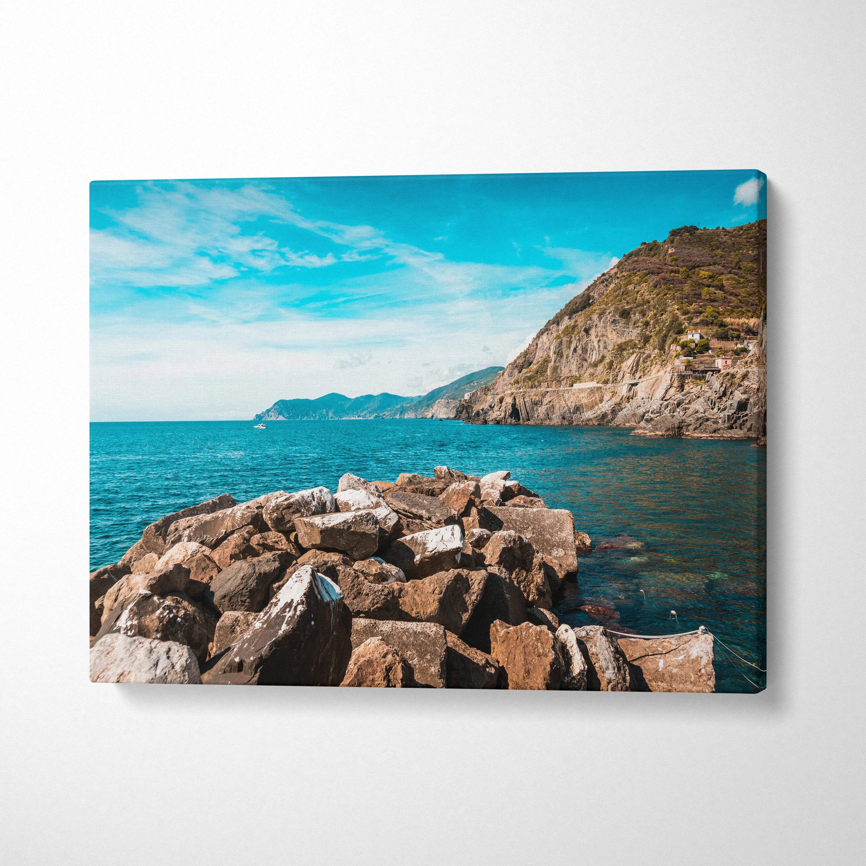 Canvas print of rocky Riomaggiore coastline with turquoise sea and hills