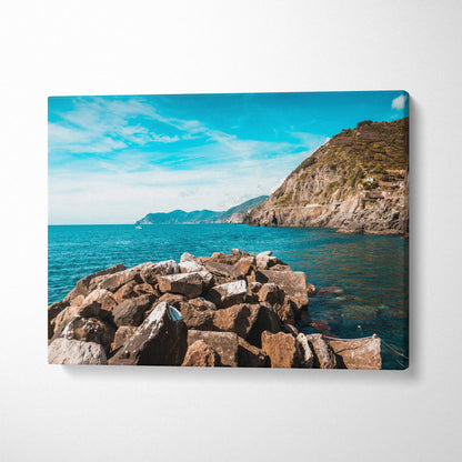 Canvas print of rocky Riomaggiore coastline with turquoise sea and hills