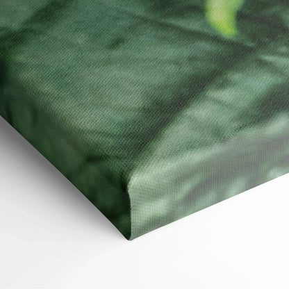 Close-up of canvas print corner with deep green textured fabric depicting leaves and floral elements in a rich, natural.