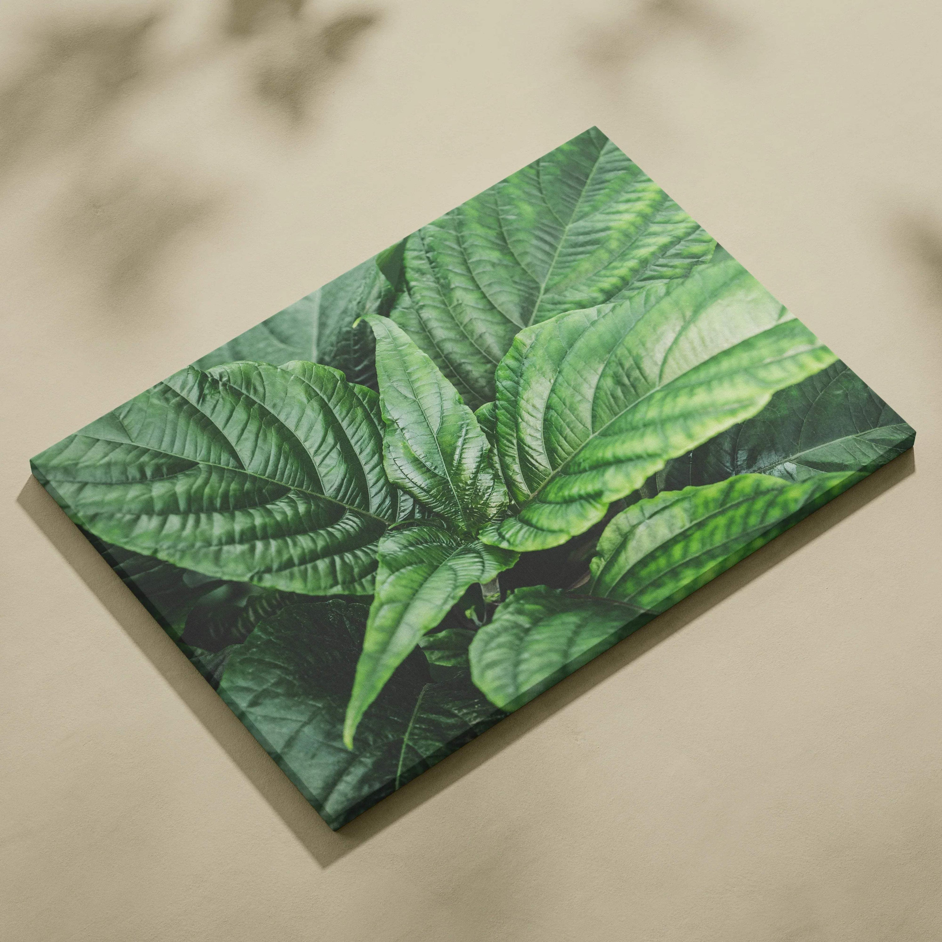 Green leafy floral design on textured canvas wall art with vibrant detailed leaves.
