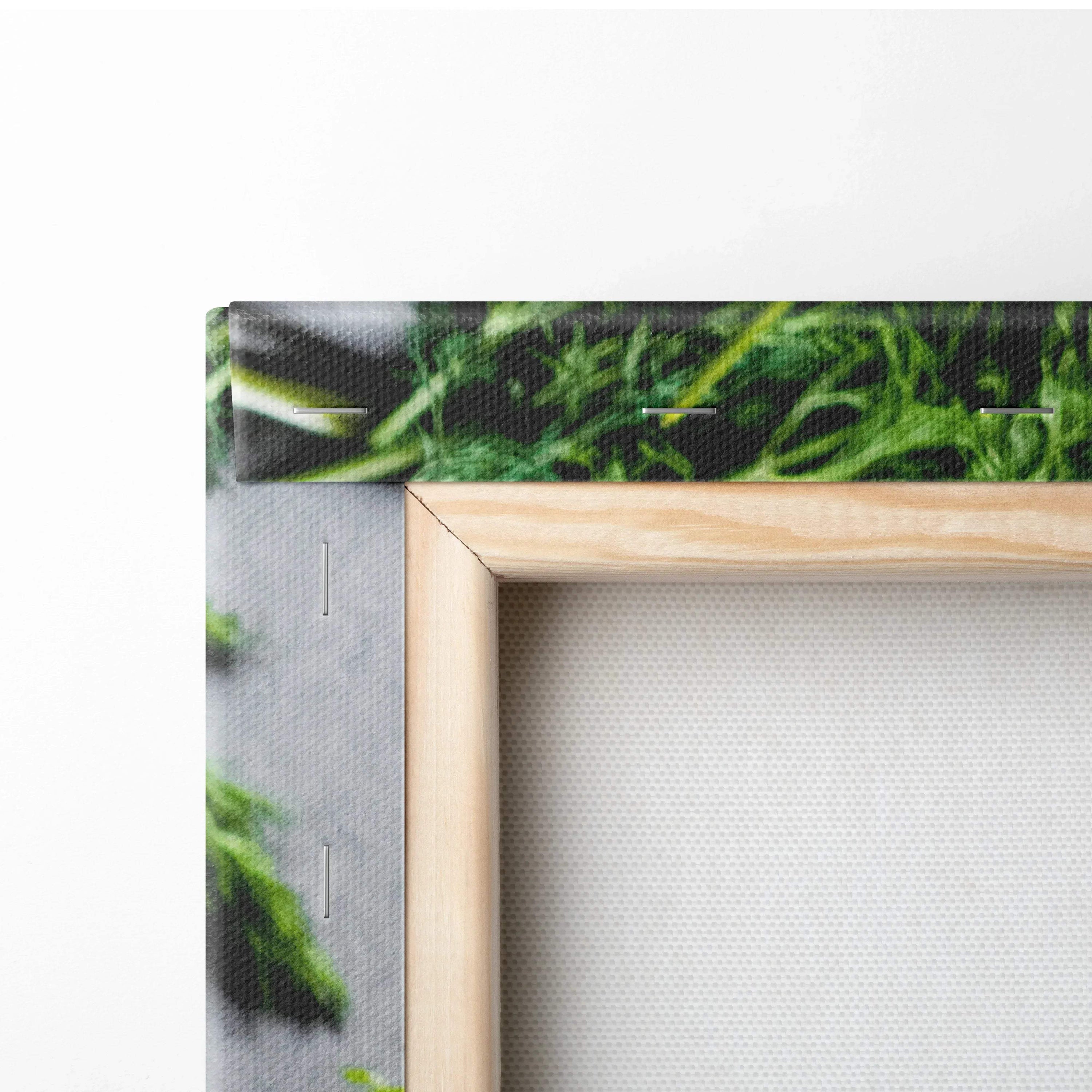 Close-up of thick wooden frame and textured canvas edge with green leafy design on food-themed wall art decor.