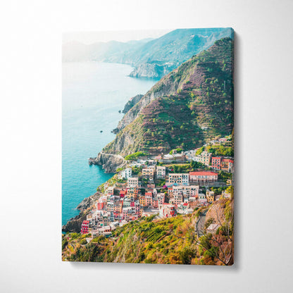 Canvas wall art featuring vibrant coastal architecture and lush green cliffs over the ocean.