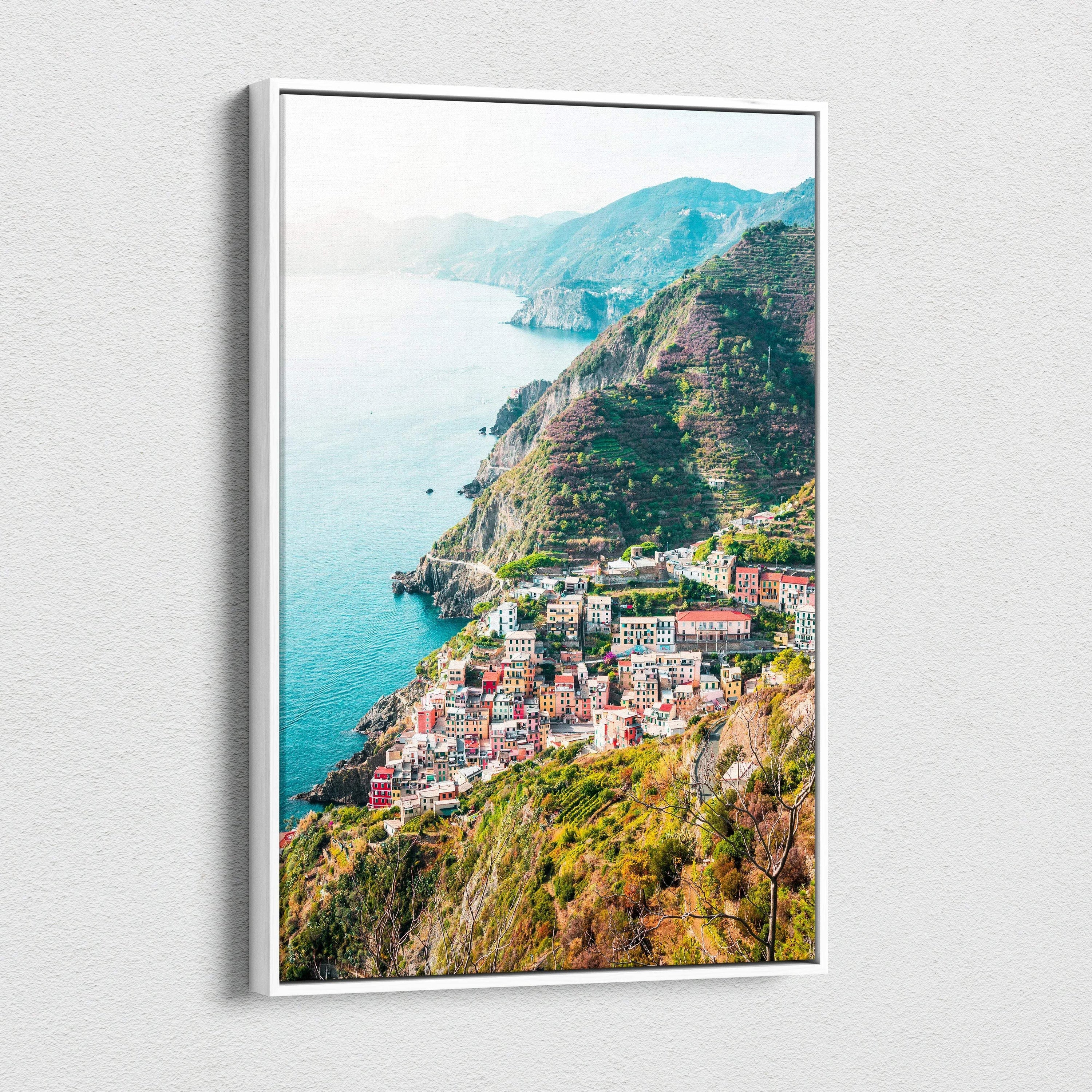 Vertical canvas wall art featuring vibrant coastal village and hillside architecture in digital art style.