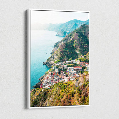 Vertical canvas wall art featuring vibrant coastal village and hillside architecture in digital art style.