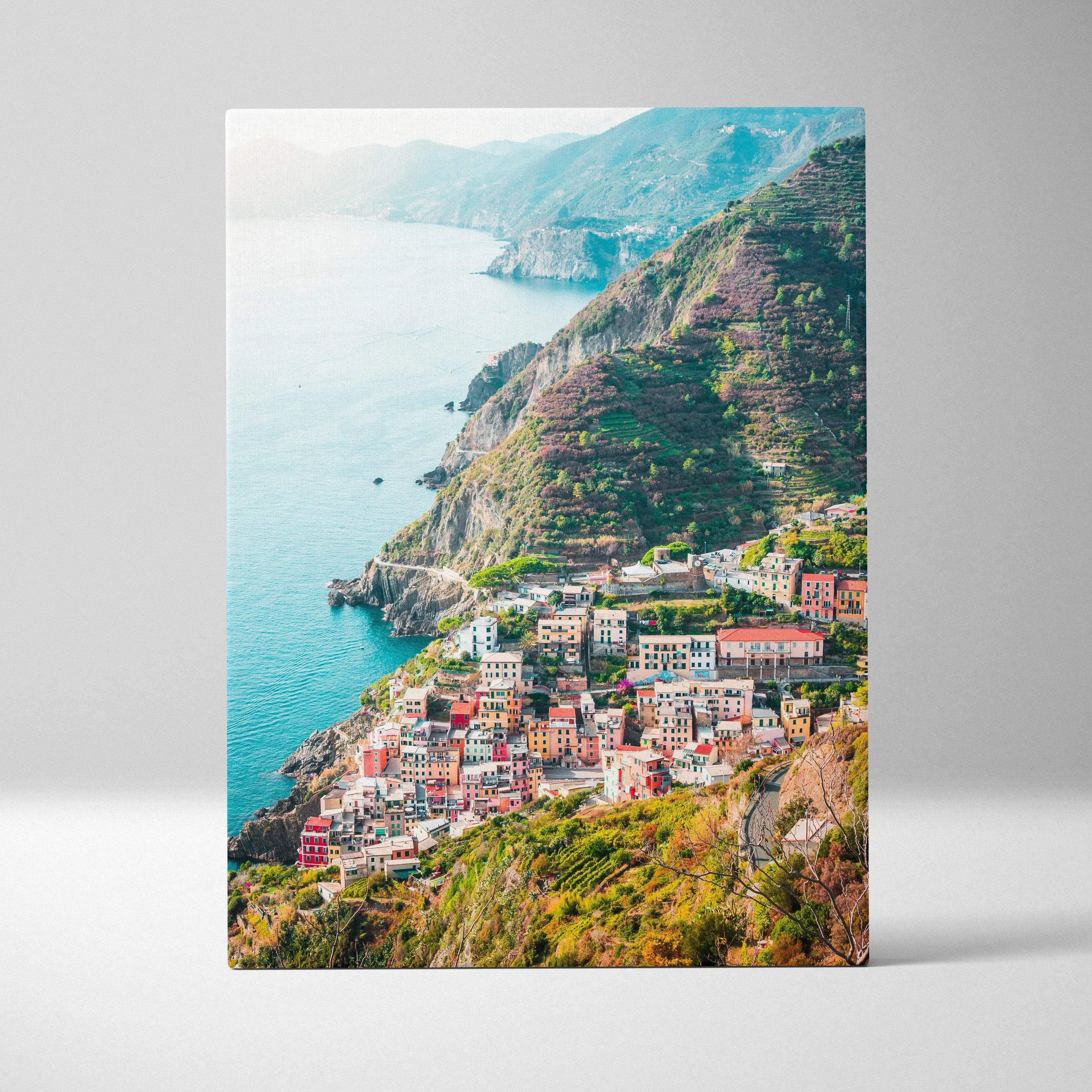 Canvas wall art print featuring colorful coastal buildings on terraced cliffs above turquoise sea.