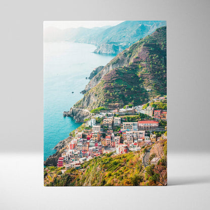 Canvas wall art print featuring colorful coastal buildings on terraced cliffs above turquoise sea.
