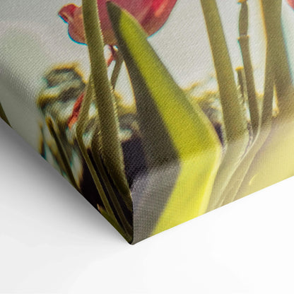 Close-up of a canvas print showing vibrant red tulips with green leaves and natural texture for wall art decor.