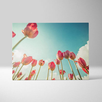 Canvas wall art featuring vibrant red tulips against a bright blue sky with soft white clouds.