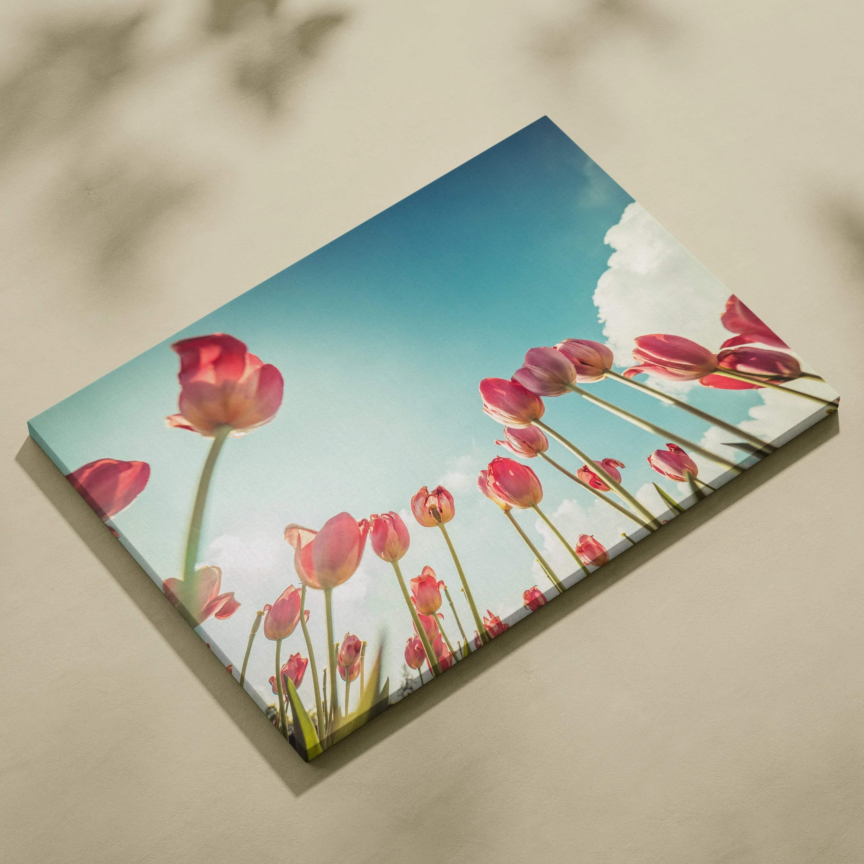 Canvas wall art featuring vibrant red tulips against a clear blue sky background with soft white clouds, perfect for modern.