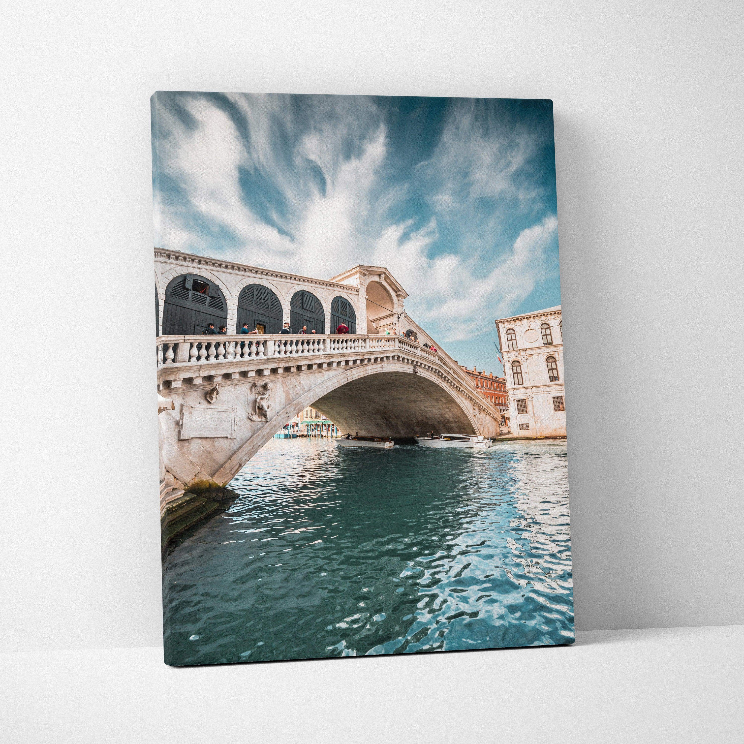 Canvas wall art featuring a detailed digital rendering of an iconic stone bridge over turquoise water under a cloudy sky.