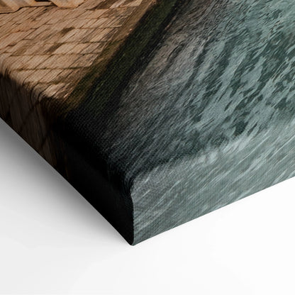 Close-up of canvas wall art featuring textured ocean waves and rustic architectural elements in dark tones.