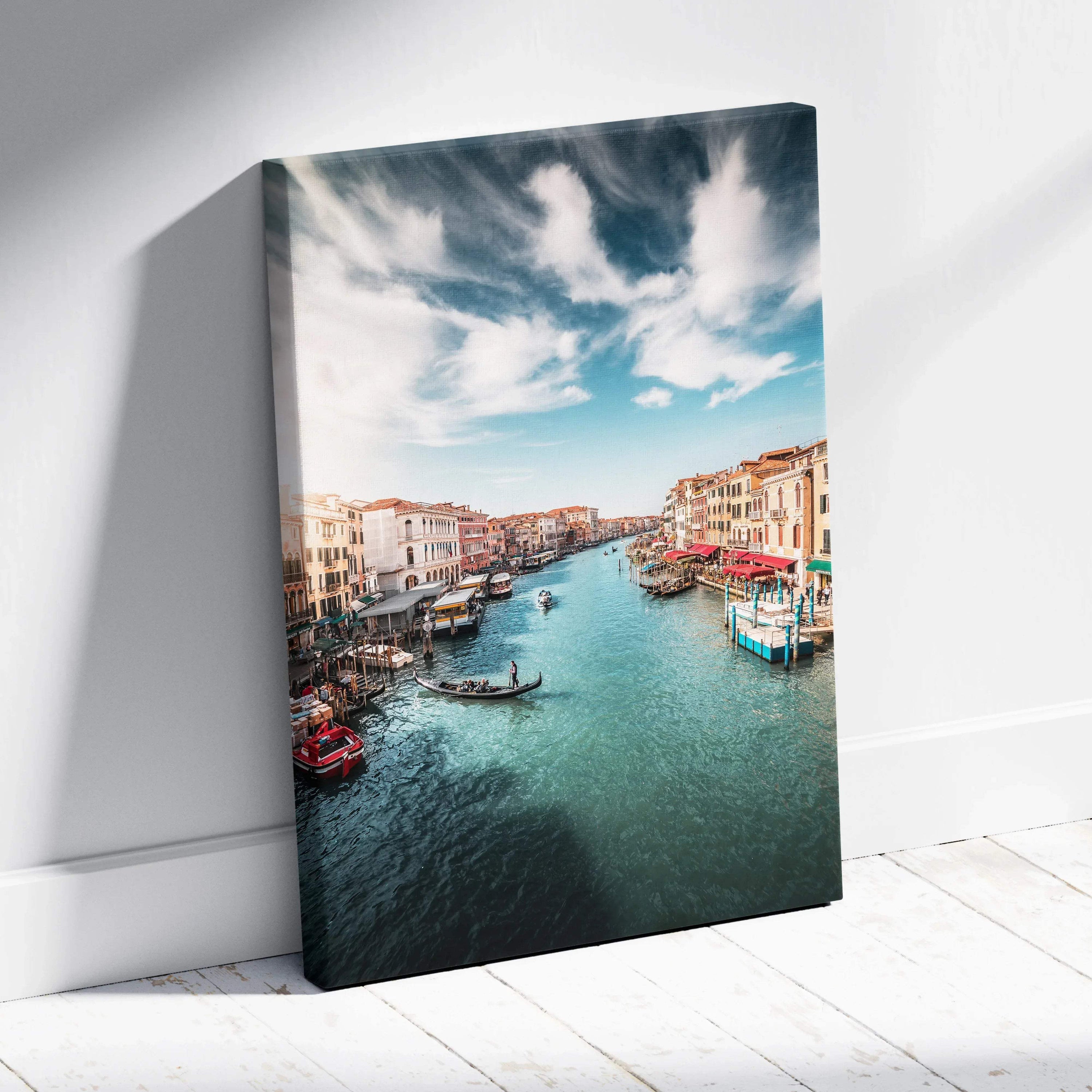 Vertical canvas wall art featuring a vibrant digital painting of boats on a canal under a cloudy blue sky.