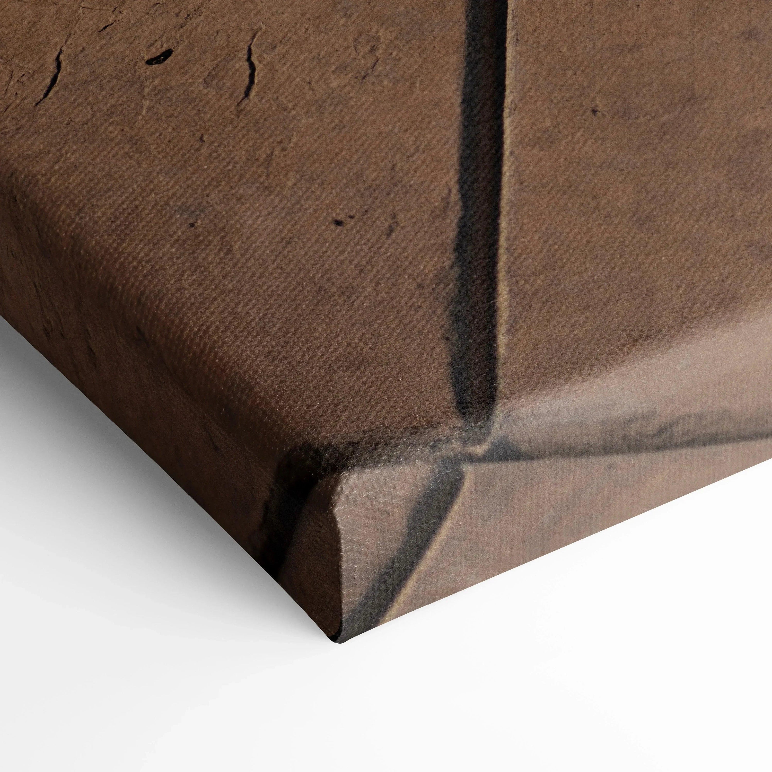 Close-up of textured brown canvas corner with wrapped edges, art wall decor detail.