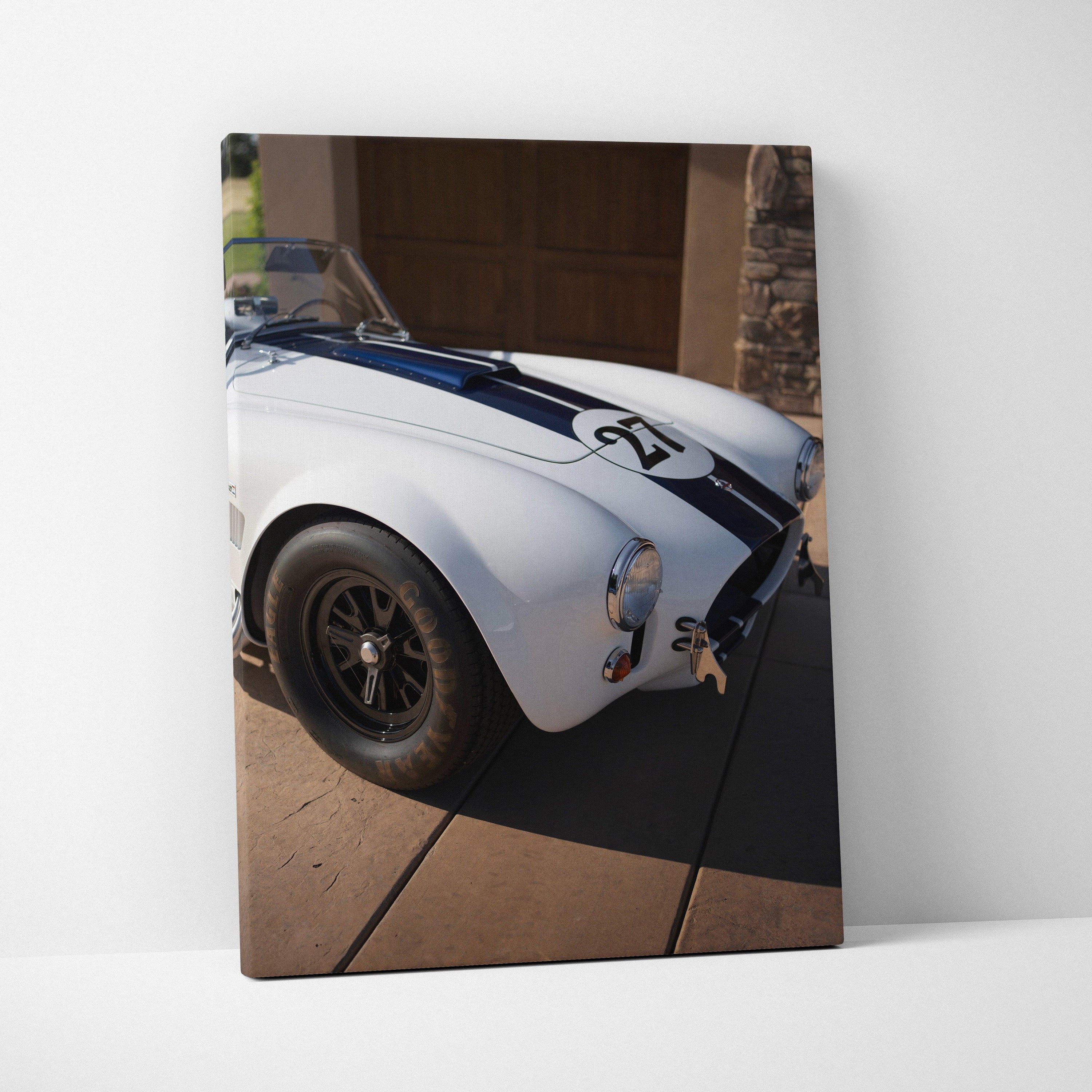 Shelby Cobra close-up on white canvas with blue racing stripe, vertical wall art print.
