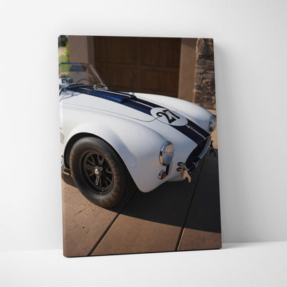 Shelby Cobra close-up on white canvas with blue racing stripe, vertical wall art print.