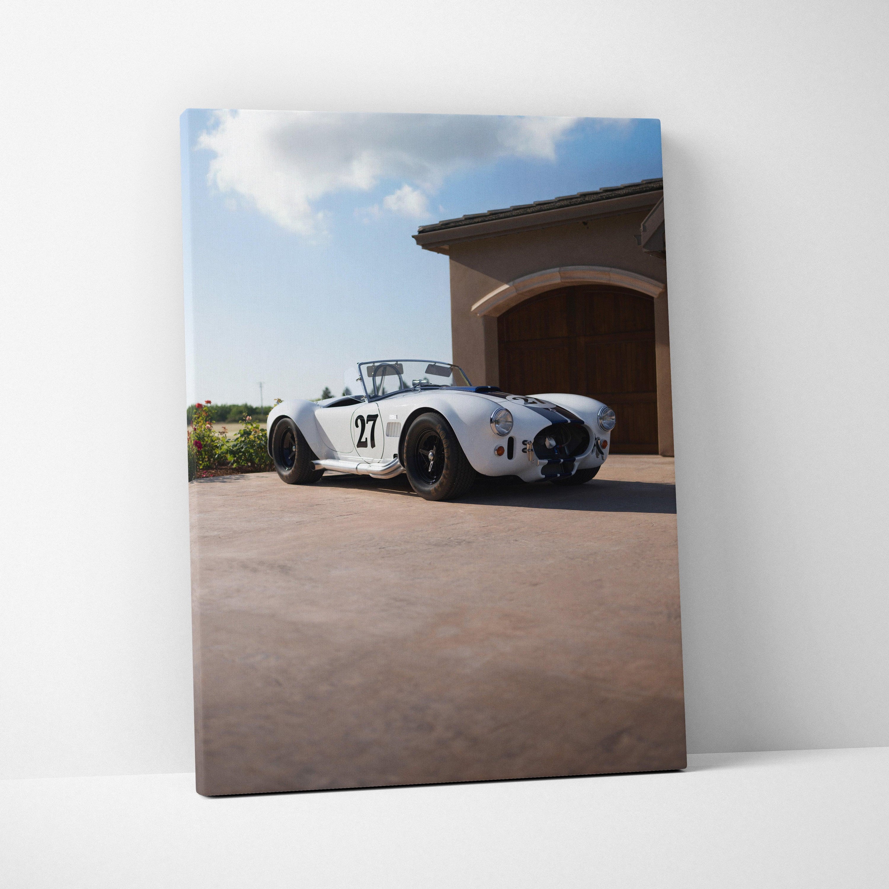 Shelby Cobra race car on driveway with blue sky canvas wall art vertical print.