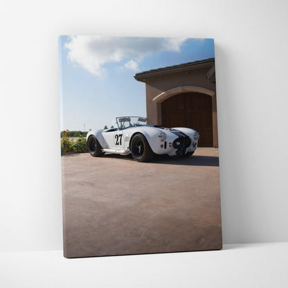 Shelby Cobra race car on driveway with blue sky canvas wall art vertical print.