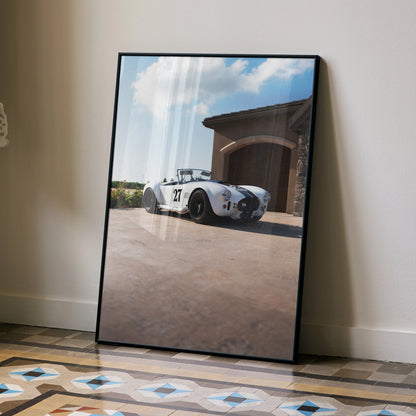Shelby Cobra high resolution poster featuring classic white car in front of garage, wall art with blue sky backdrop.