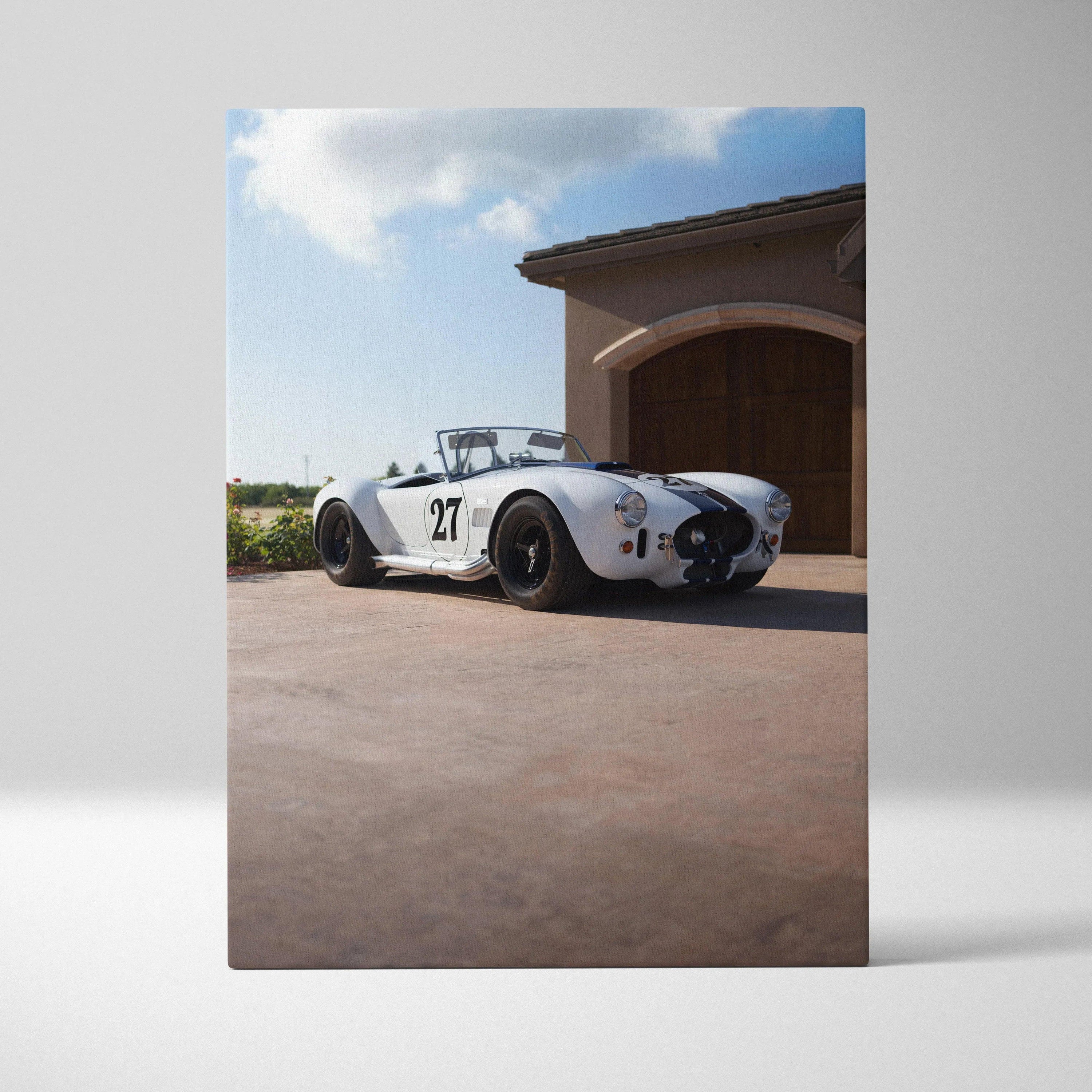 Shelby Cobra vintage race car on driveway canvas wall art with clear sky background.