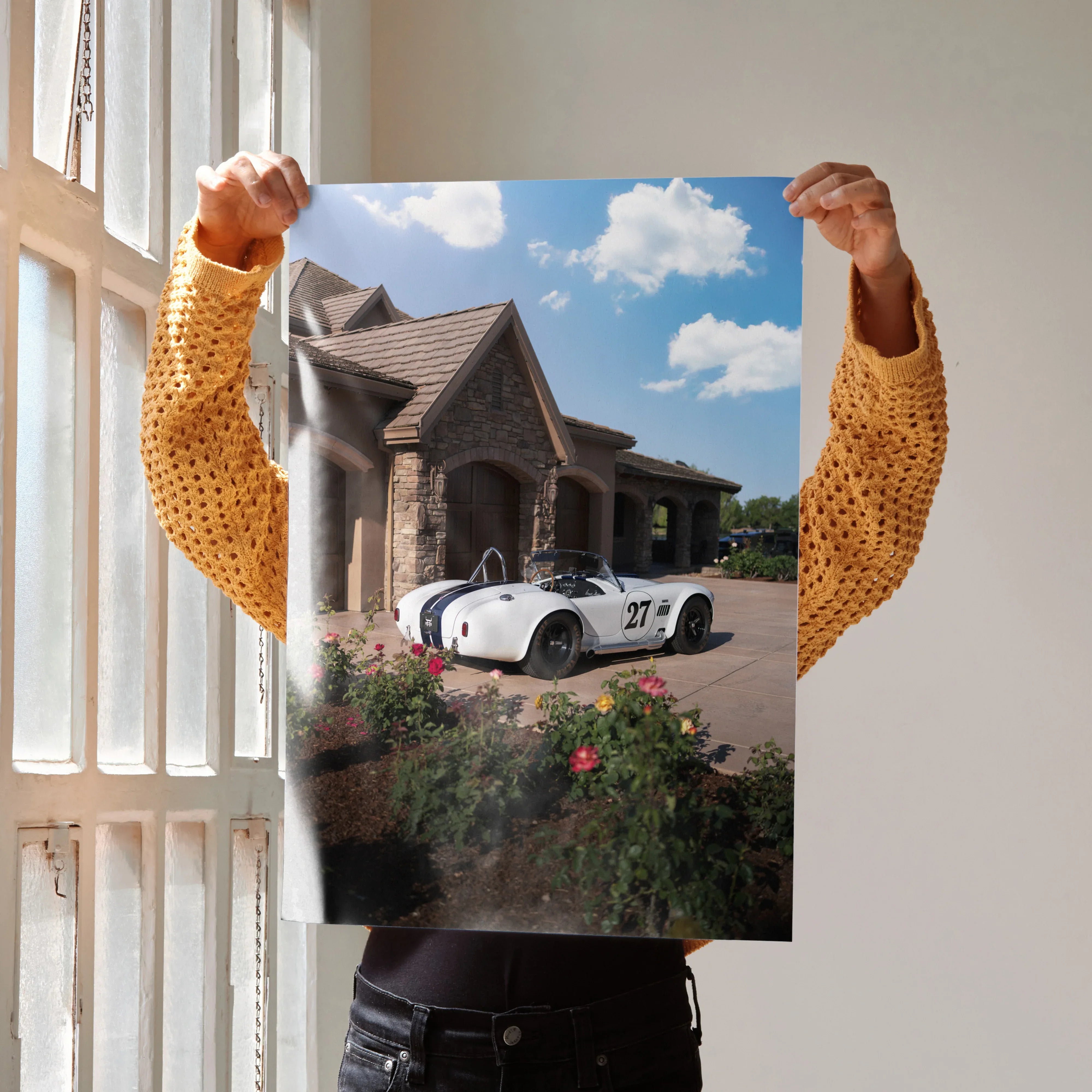 Shelby Cobra race car parked in front of stone house on wall art poster.