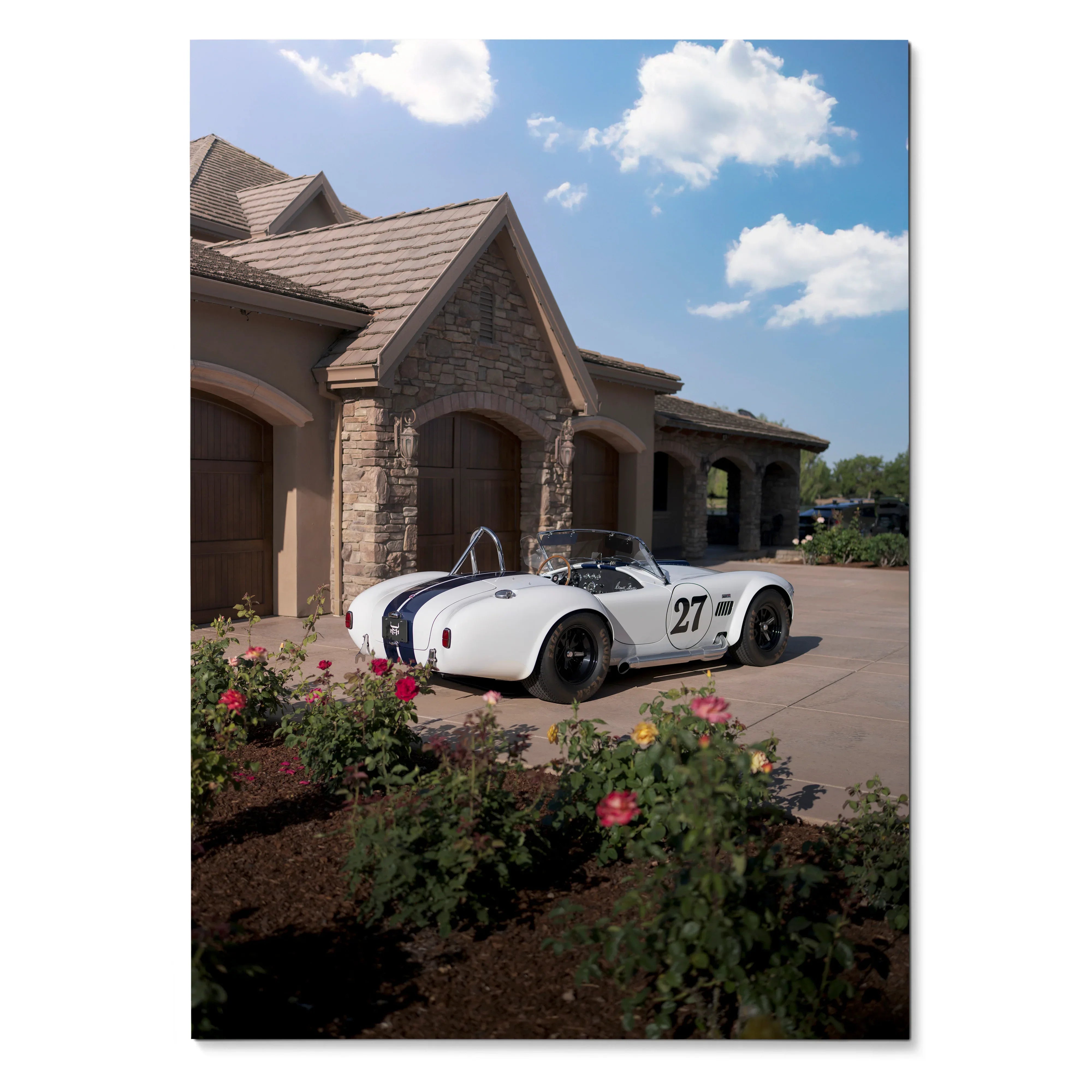 Shelby Cobra convertible race car with number 27 parked outside stone house poster wall art.