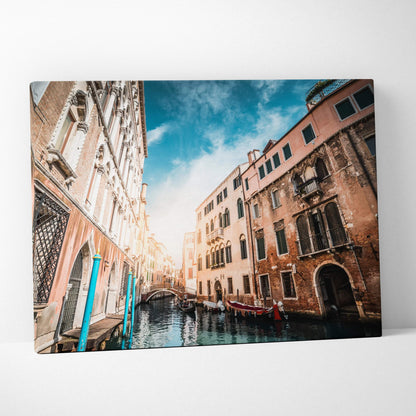 High-resolution canvas wall art featuring an urban canal scene with historic buildings and gondolas under a vibrant sky.
