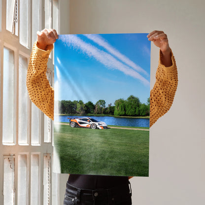 McLaren 570S sports car on grassy field near lake under clear blue sky poster wall art.