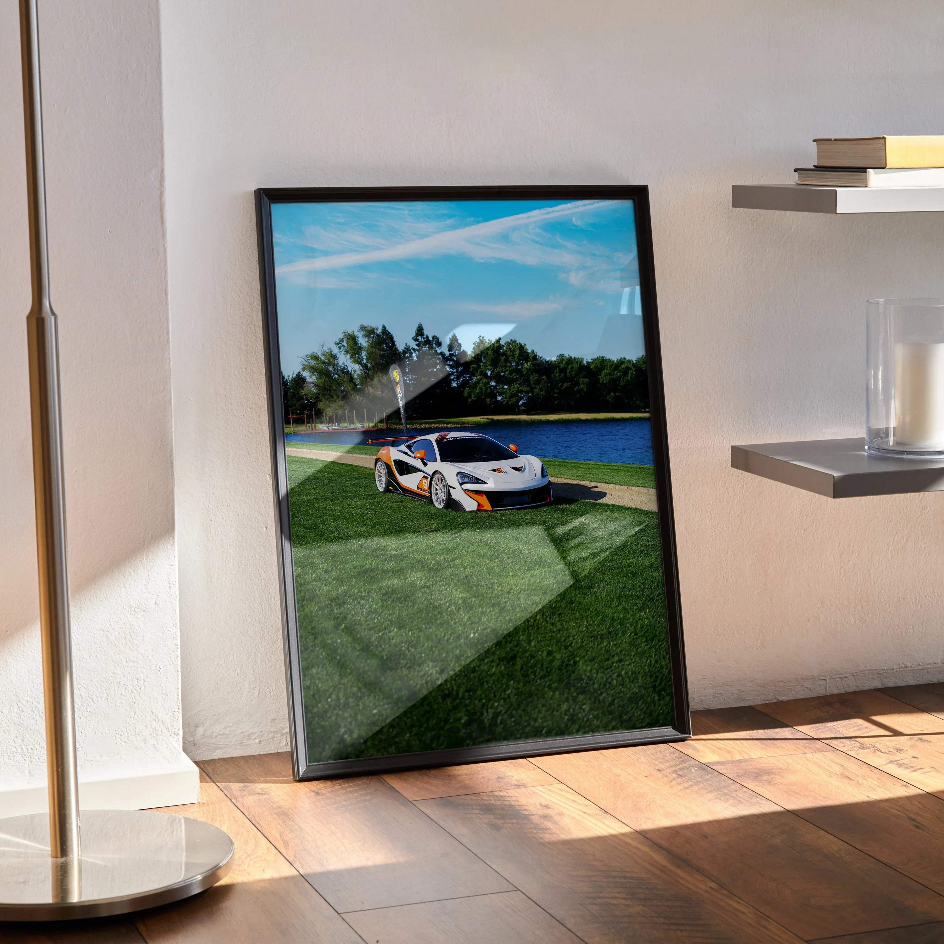 McLaren 570S parked on racetrack poster with vibrant blue sky, framed wall art.