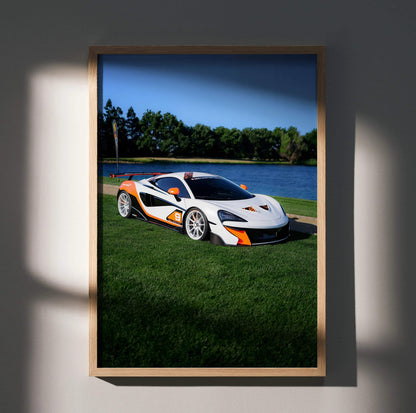 McLaren 570S parked on grass by water under clear blue sky poster wall art.