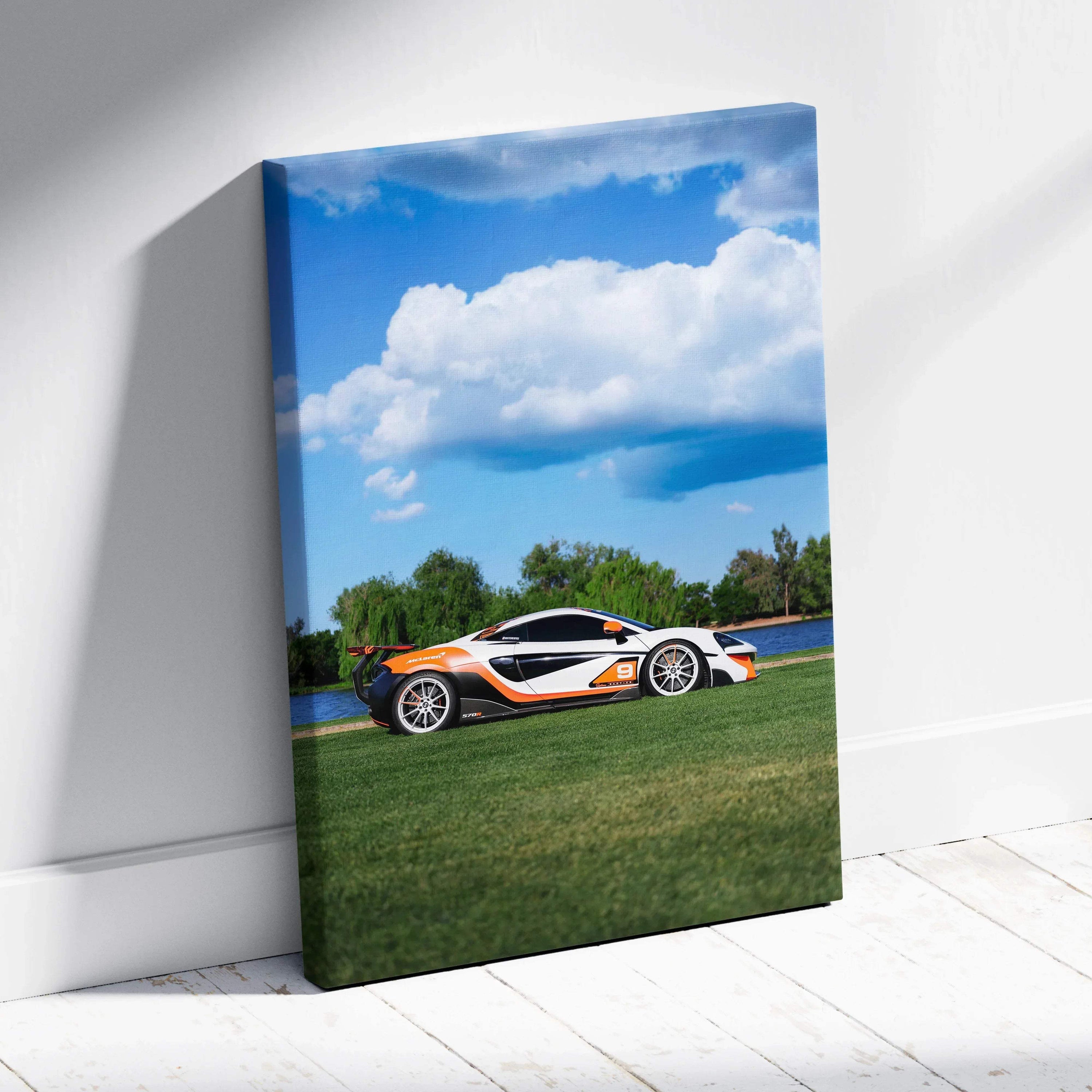 McLaren 570S sports car on green grass with blue sky canvas wall art in vertical format.