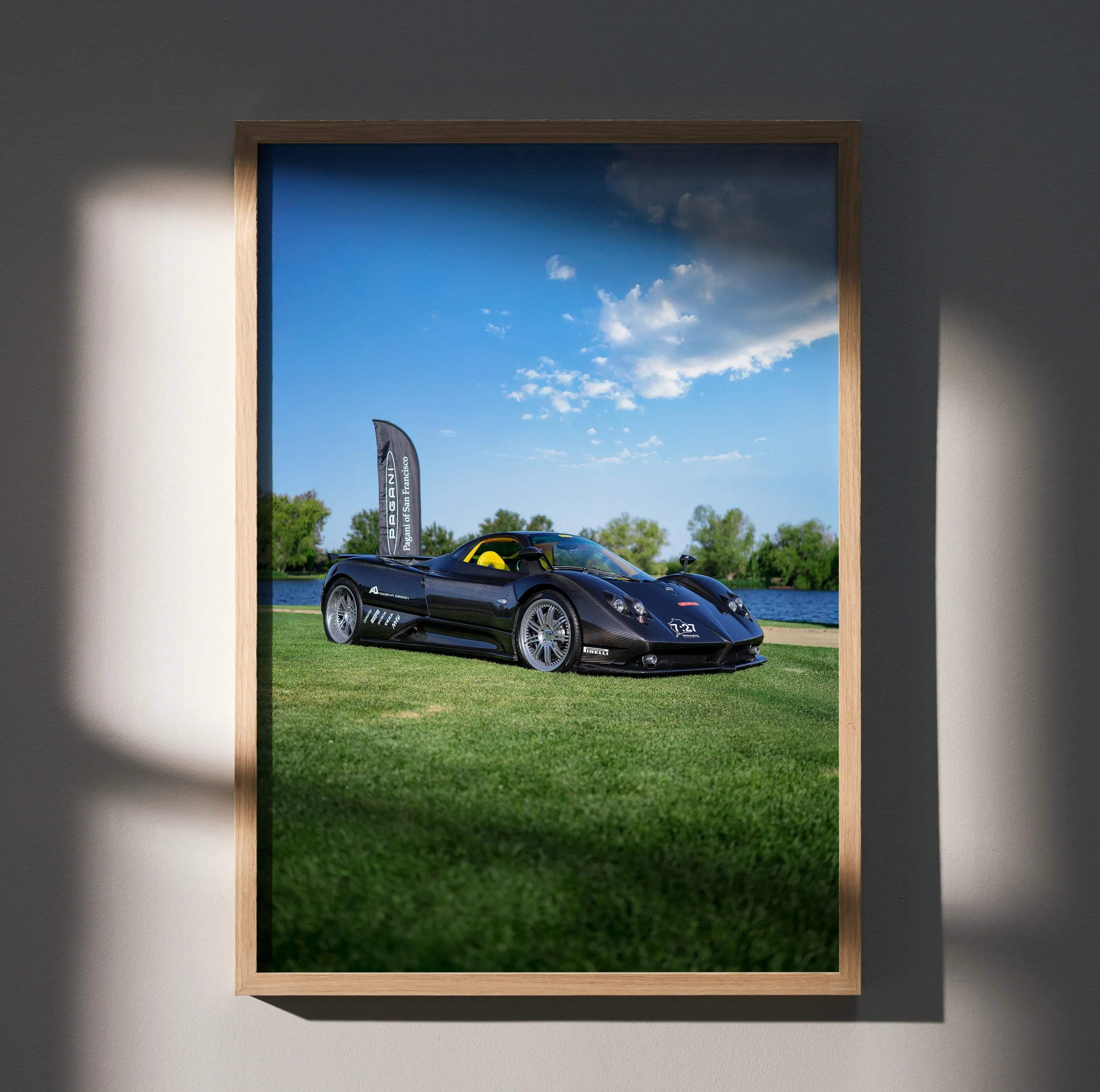 Pagani Zonda F Clubsport parked on grass under blue sky poster wall art with wooden frame.