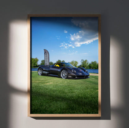 Pagani Zonda F Clubsport parked on grass under blue sky poster wall art with wooden frame.