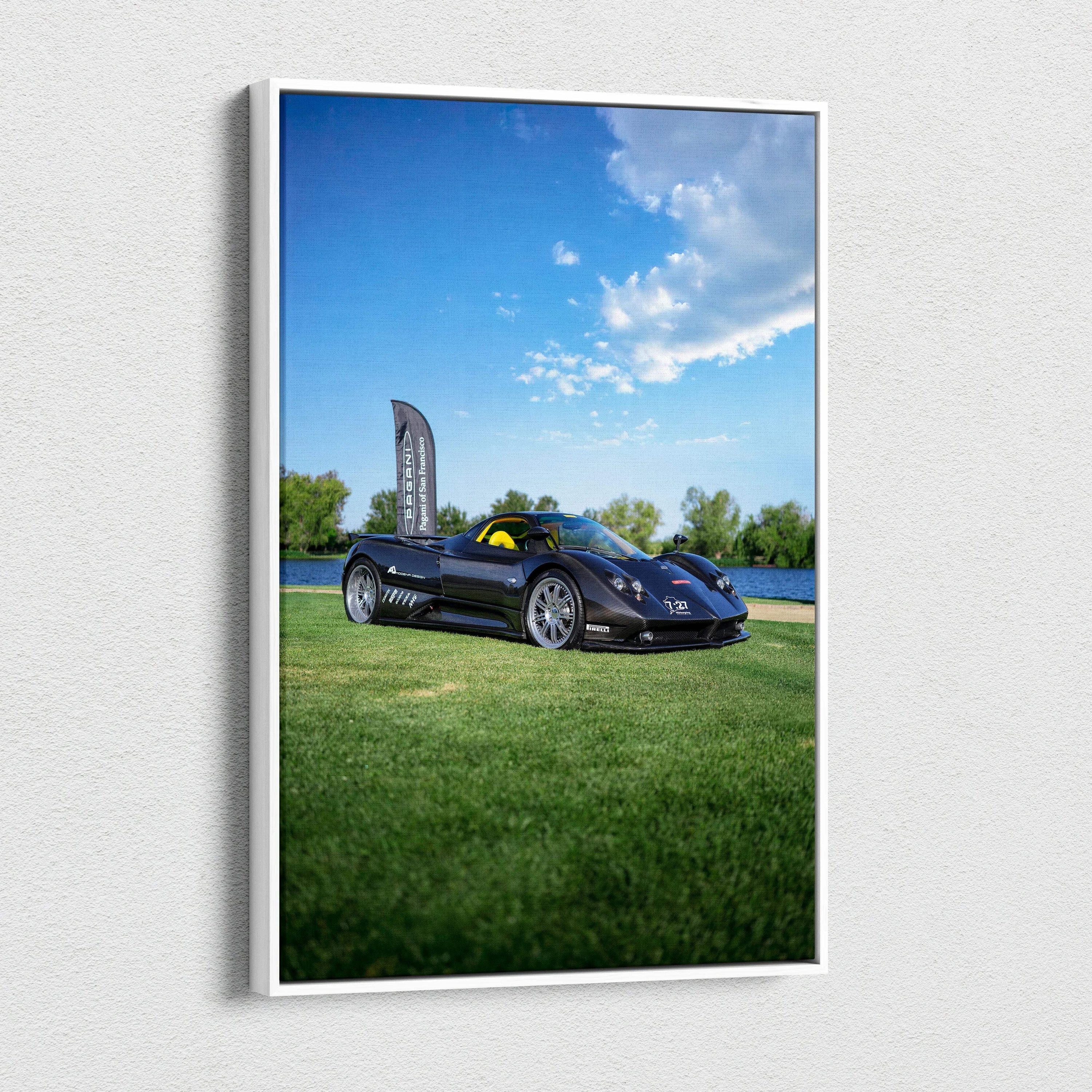 Vertical canvas art featuring a black Pagani Zonda F Clubsport on green grass under a bright blue sky.