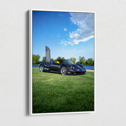 Vertical canvas art featuring a black Pagani Zonda F Clubsport on green grass under a bright blue sky.