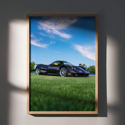 Pagani Zonda F Clubsport black sports car on grass with blue sky poster wall art.